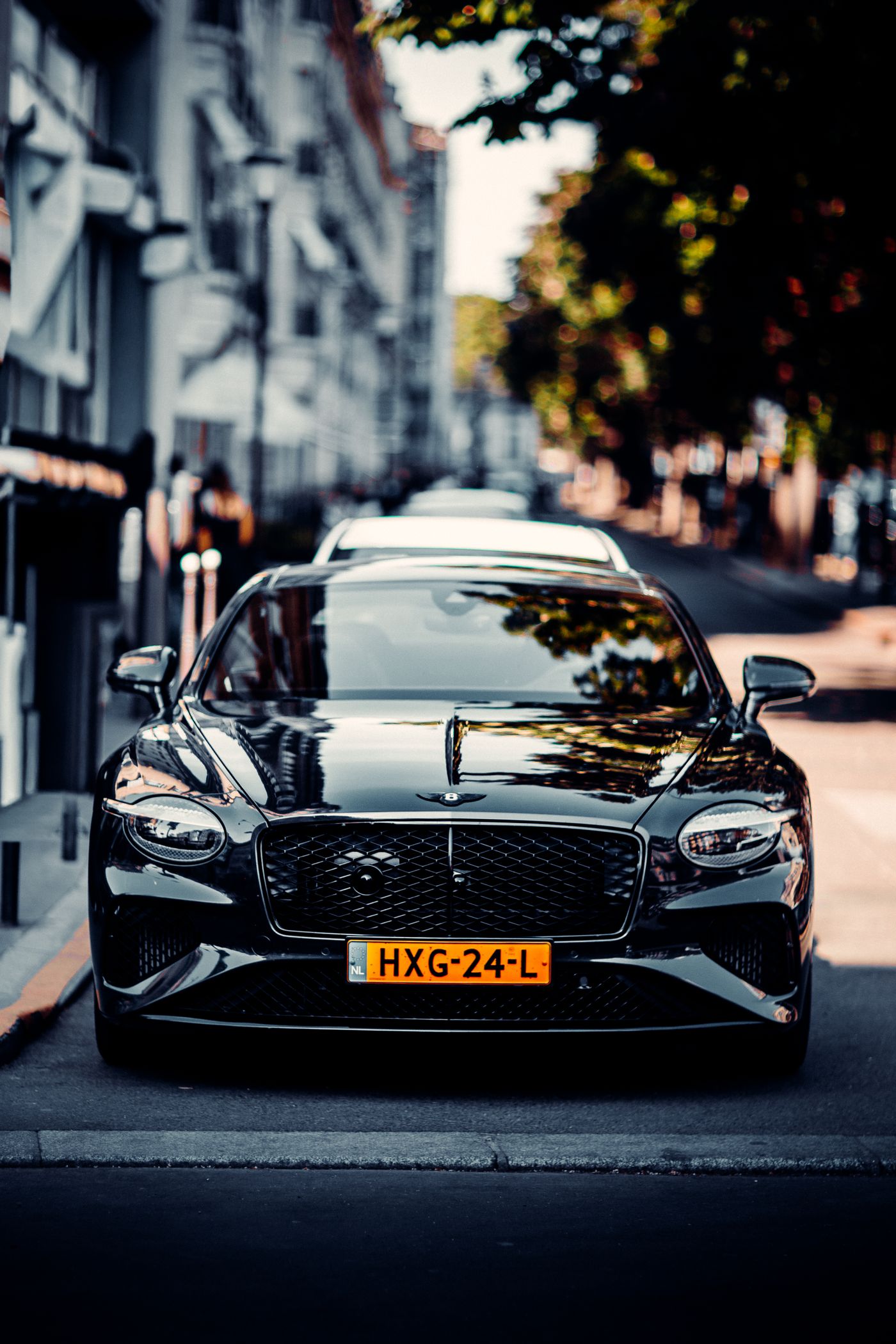 Glossy black luxury car detailed to a mirror finish, front view
